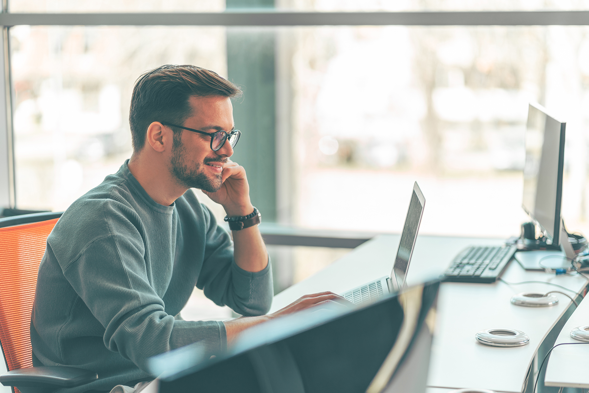 Man look at a laptop screen at work